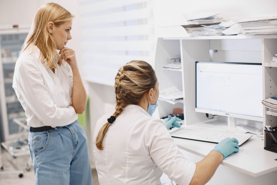 Two clinic staff looking at a screen together